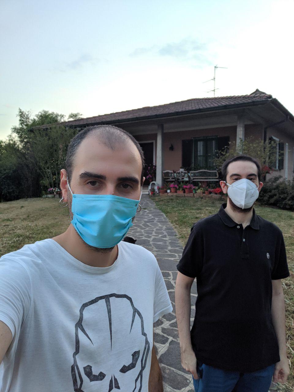Sergio and I wearing face masks in front of his house